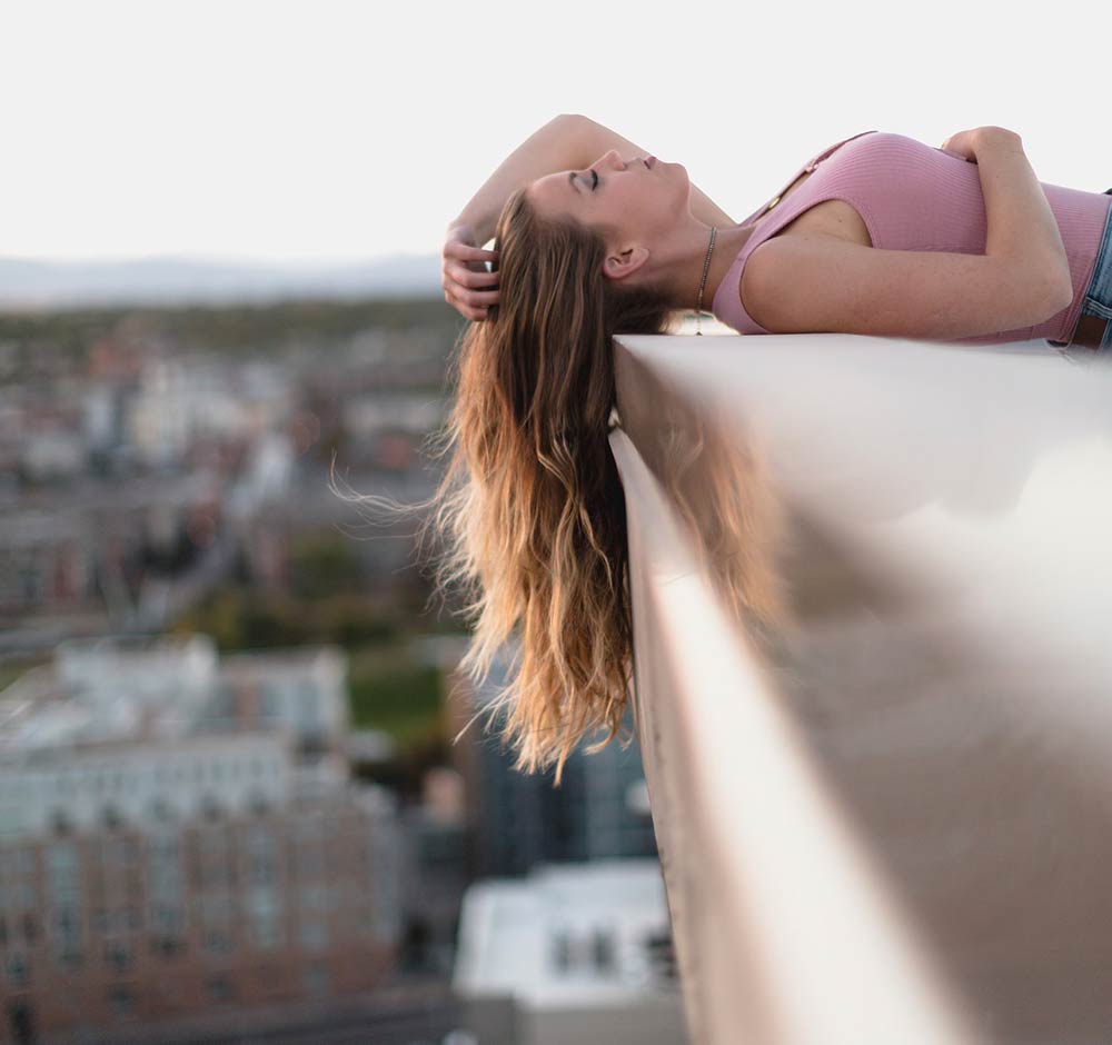 Thinktank has the edge: a model looking up, over the edge of a building in Central Manchester